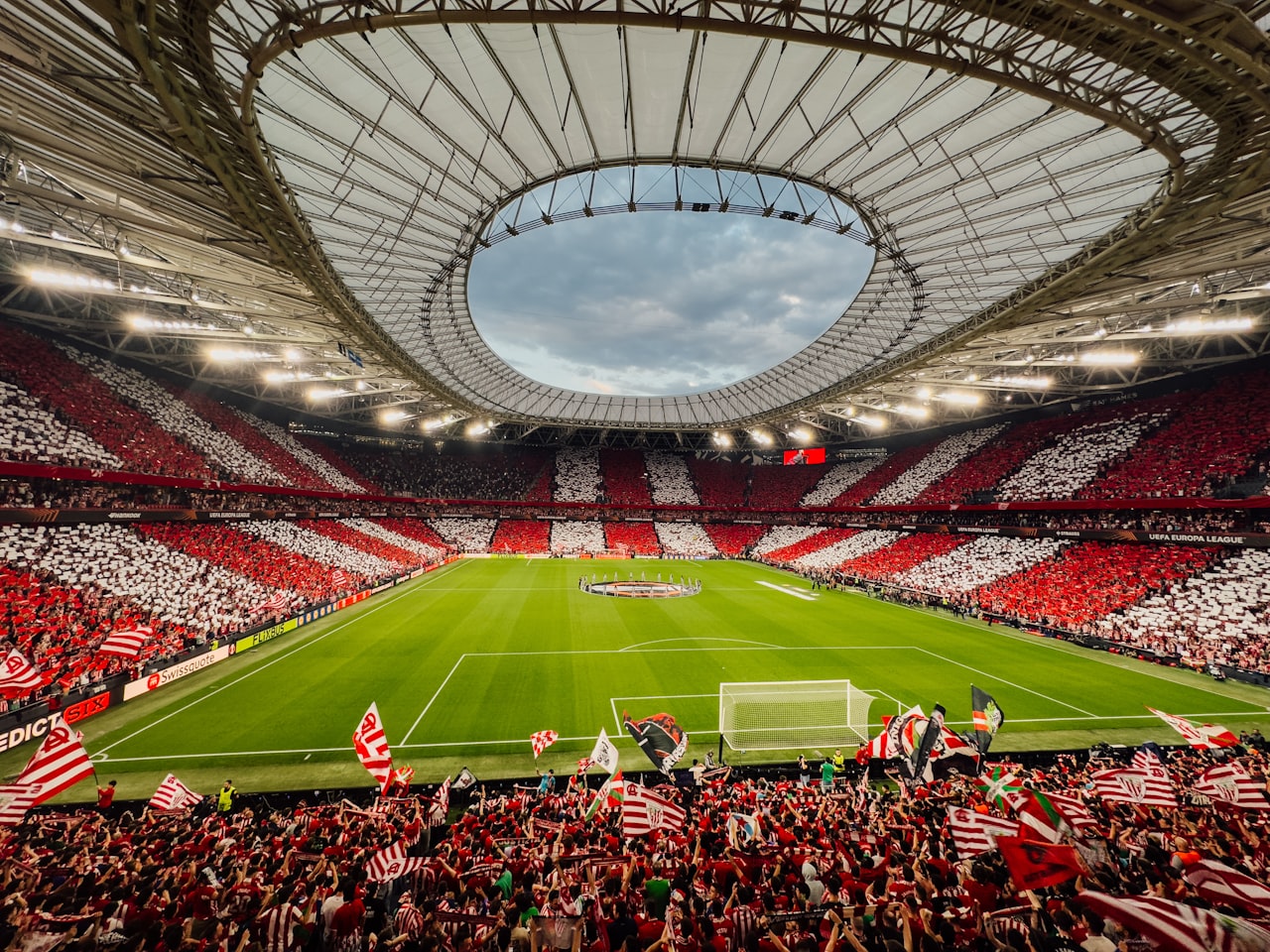 Football fans celebrating inside a packed stadium at the World Cup