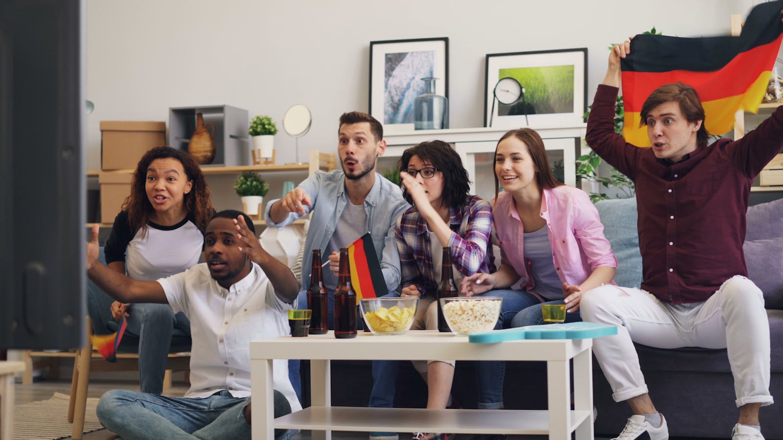 Group of colleagues watching a football match together