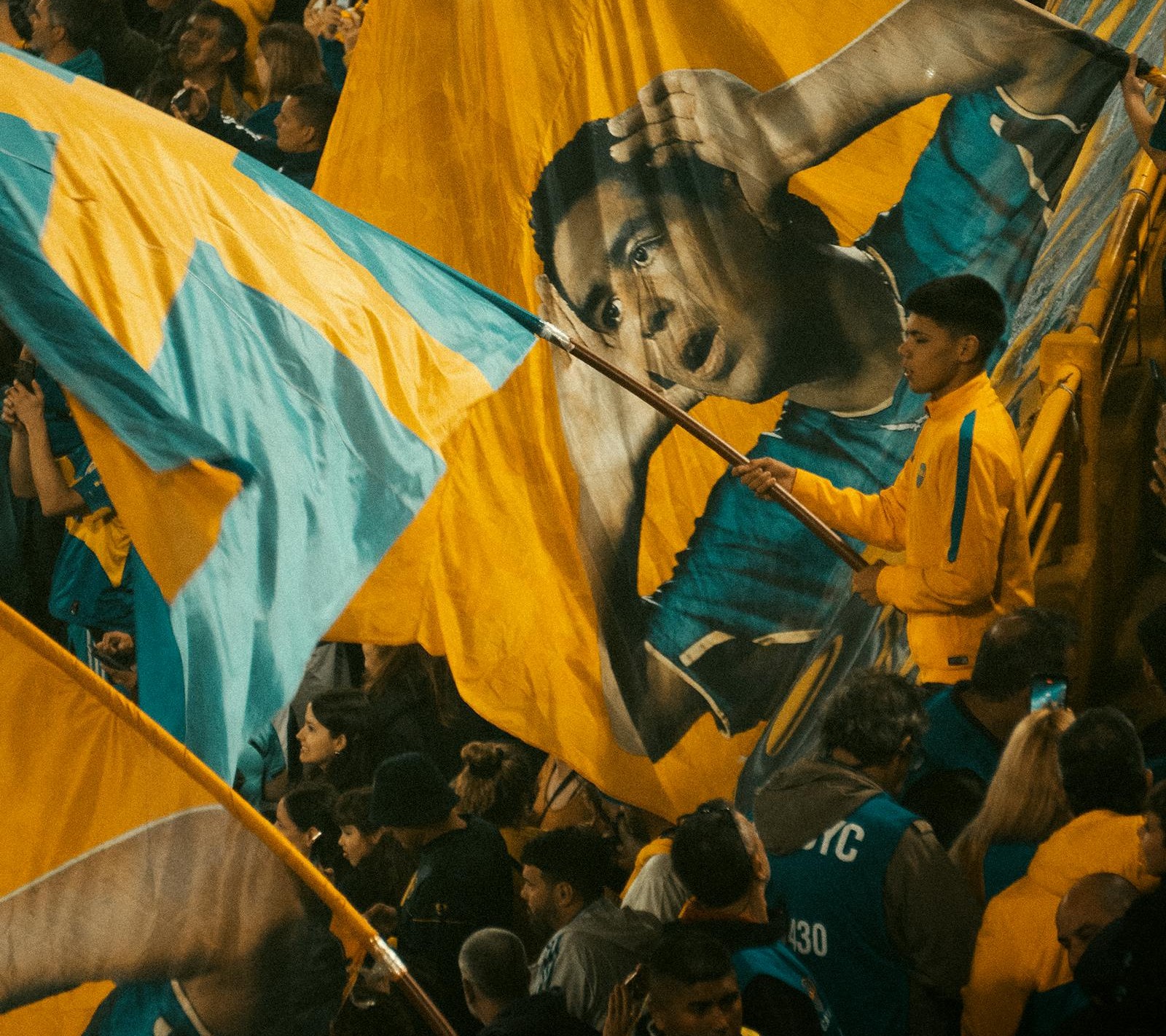Football fans with flags in a packed stadium