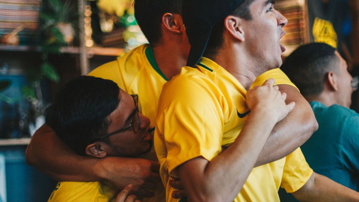 Football fans celebrating a goal while watching a match