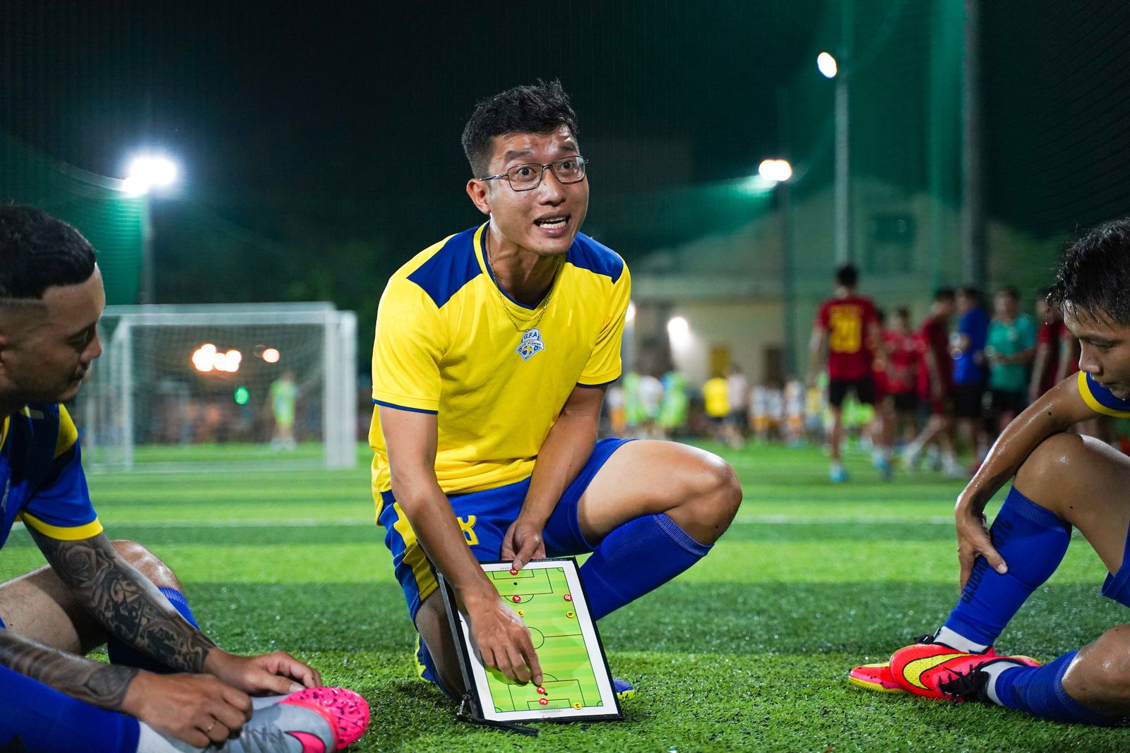 Coach explaining football strategy on a tactic board